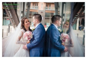 bride and groom reflection in window