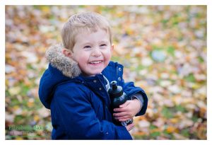 boy laughing in the woods