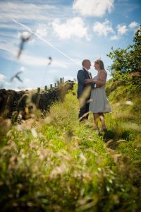 couple embrace in summer flowers