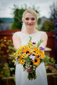 bride holds out bouquet