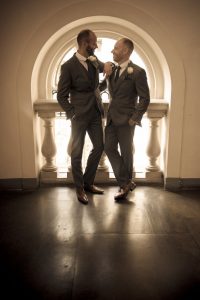 Two groom newlyweds silhouette window light