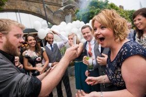 woman at wedding guest looks shocked by magic trick