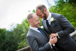 couple cuddle after wedding ceremony london in background