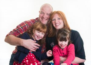 studio photo of family of four