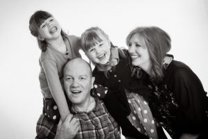 black and white pic of family laughing