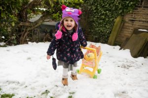 child playing in snow