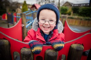 little boy laughing at camera