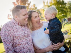 mum and dad looking at little boy excited