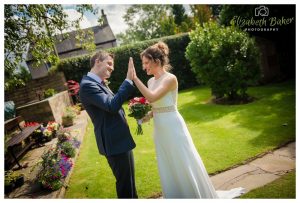 bride and groom high five before ceremony