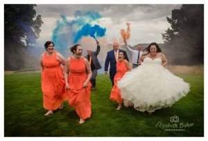bridal party run from smoke bombs