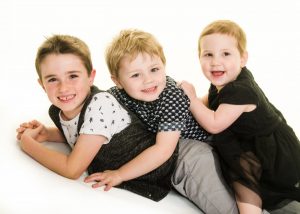 three kids pile on