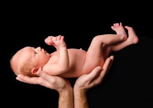Newborn baby being held by dad