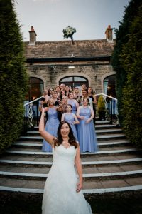 bride and bridesmaids throwing the bouquet