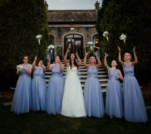 bride and bridesmaids throwing the bouquet