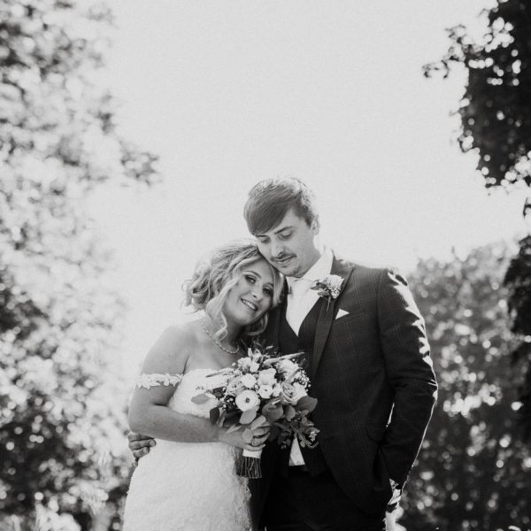 black and white image of couple surrounded by trees