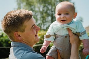 baby and dad playing out