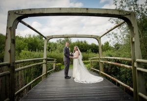 bride and groom portrait on metal bridge