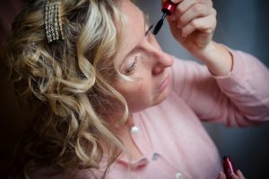 close up of bride doing makeup