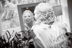 bride sees her hair and makeup in mirror