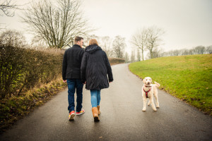 man and woman walking away in fog, dog looking at camera