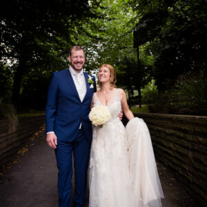 bride and groom have a laugh outside the hotel