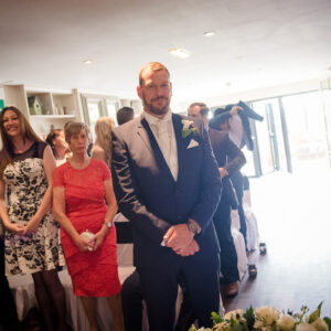 groom waits for bride top of aisle