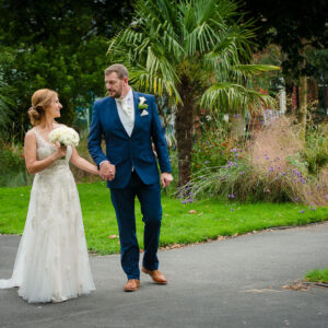 newlyweds walking in park
