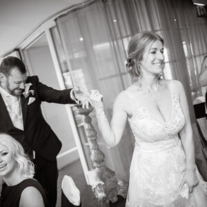 bride leads the groom into the reception