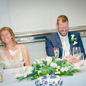 newlyweds laughing during speeches