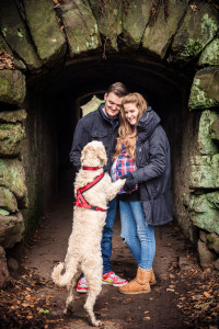 dog jumping up at couple for a stroke