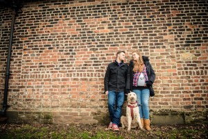 romantic leaning on large brick wall