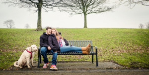 married couple cuddling on bench