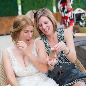 The bride is shown something shocking on a guests phone