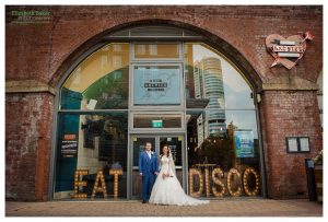 couple stand with sign