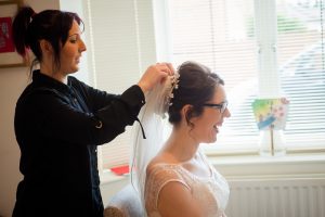 Bride has her veil secured