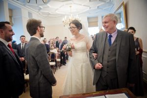 groom and bride laugh beginning of ceremony