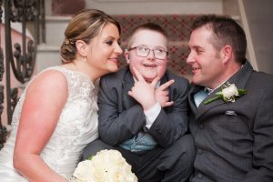 Bride and groom and son having fun