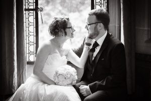 Newlyweds cuddle in window