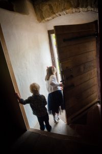 kids exploring through barn door interior shot