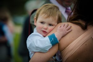 shot of boy hugging mum who is the bride