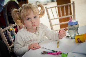 child guest playing with their wedding day play kit