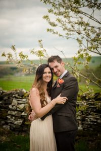 couple looking at camera hugging