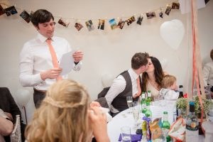 couple kiss and best man gives speech