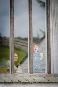 little bot looking through window