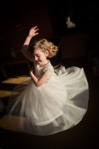 flower girl spins in shadow lighting