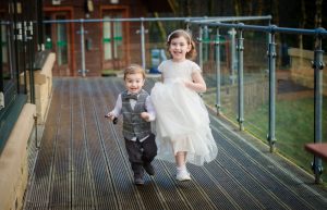 son and daughter of the couple run outside