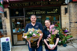 Meltham Florists standing in front of their shop