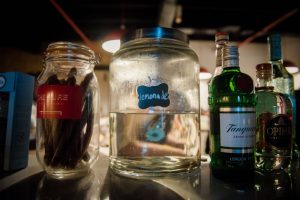 drinks in large jars backlit