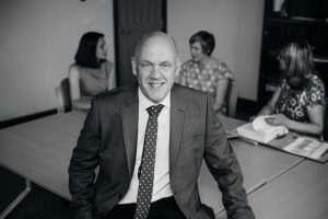 man in suit at desk