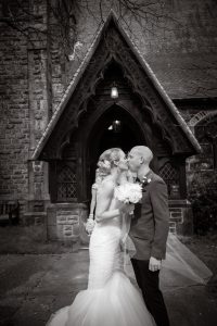 brand new newlyweds kiss outside church